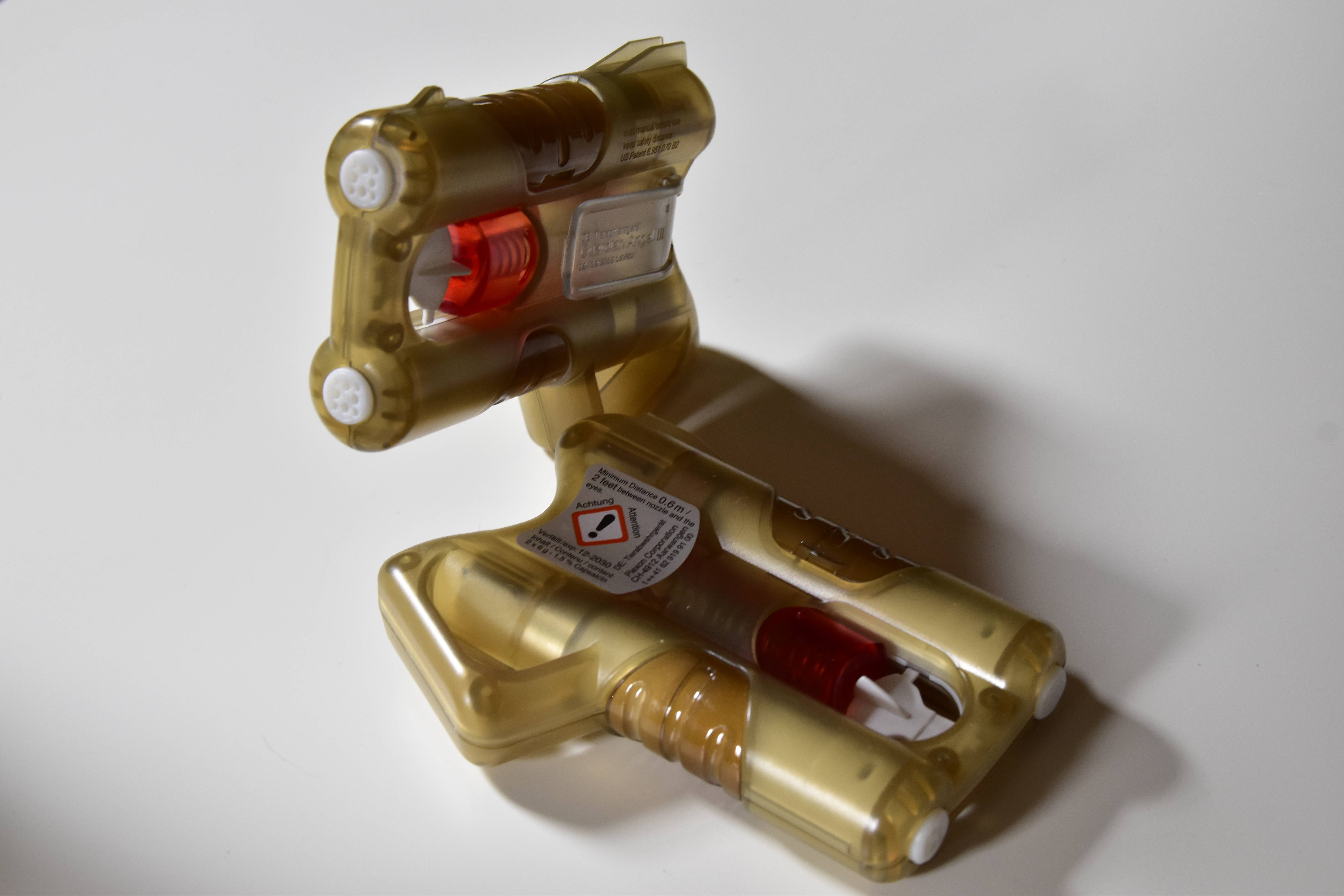 Guardian Angel - złoty miotacz substancji drażniących z widocznymi czerwonymi nabojami